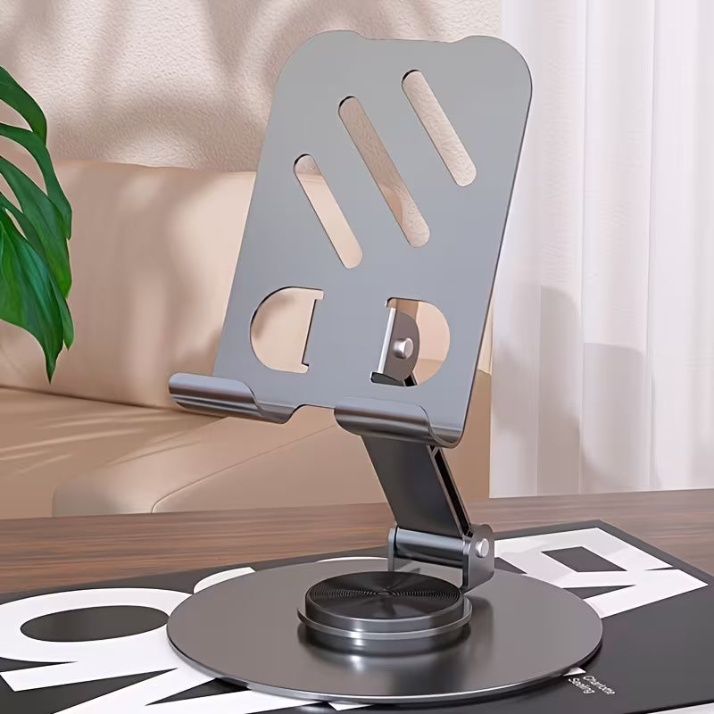 Metallic laptop stand on a desk with a blurred indoor background