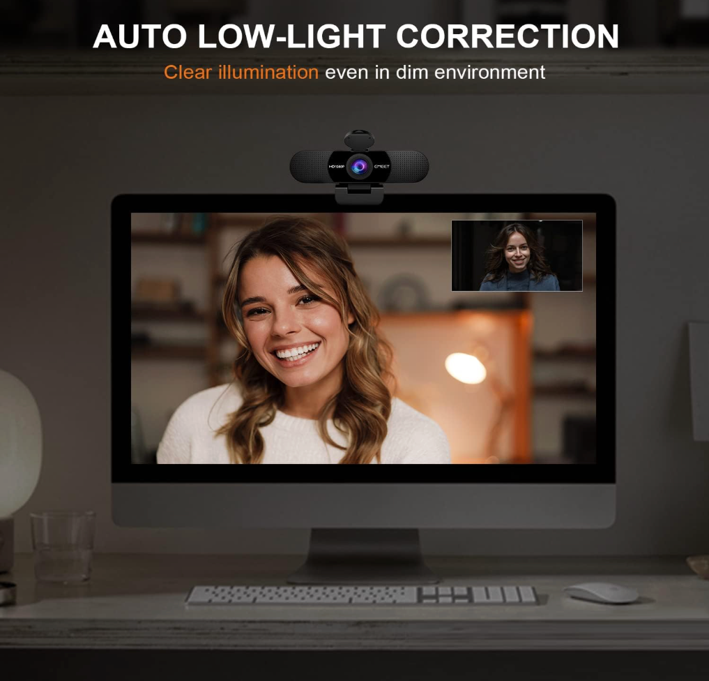 Computer monitor with webcam displaying a person, emphasizing auto low-light correction feature.