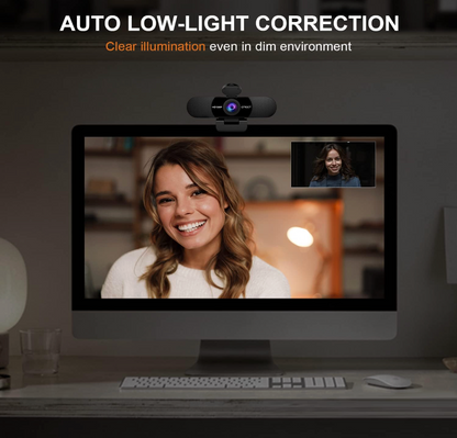 Computer monitor with webcam displaying a person, emphasizing auto low-light correction feature.