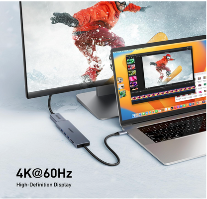 Laptop with a USB-C hub connected to a monitor displaying a snowboarder, with '4K@60Hz High-Definition Display' text.