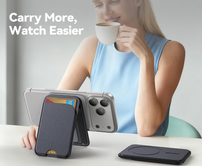 Woman holding a phone with a case, card holder, and wireless charger on a table.