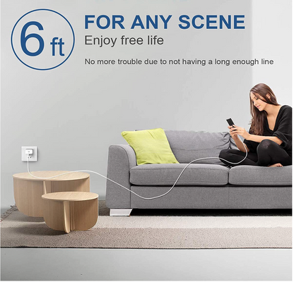 A woman sits on a gray sofa using a phone while a long white cord runs from a wall outlet to a small round wooden side table in the foreground. Text at the top reads '6 ft', 'Enjoy free life', and 'No more trouble due to not having a long enough line.