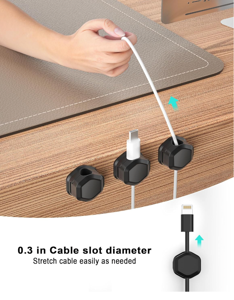 A close-up of a hand stretching a white cable through a black cable slot organizer on a wooden desk, with two additional slots shown holding cables. Text at the bottom reads '0.