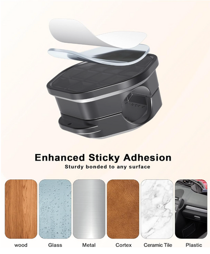 A black adhesive bin with a transparent cover shown on a light beige background, with text reading 'Enhanced Sticky Adhesion' and six material sample strips below labeled wood, Glass, Metal, Cortex, Ceramic Tile, and Plastic.