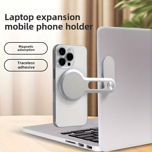 Laptop expansion phone holder with magnetic吸附and traceless adhesive features on a laptop.